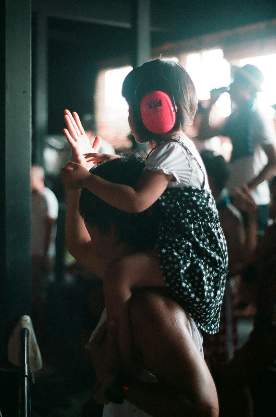 A father and daughter dancing together to music in mid-summer.